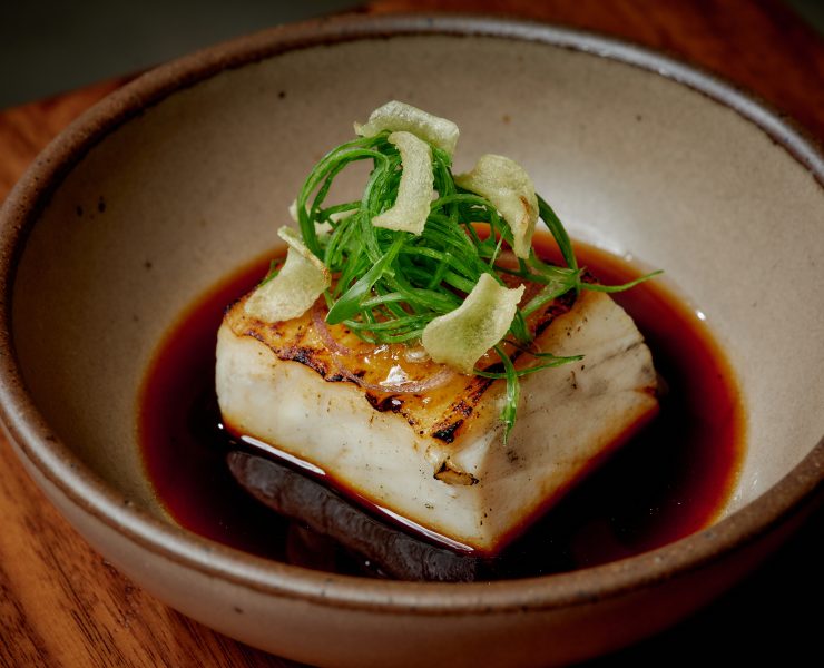 Grilled walu walu fish with green garnish at Uchi Scottsdale