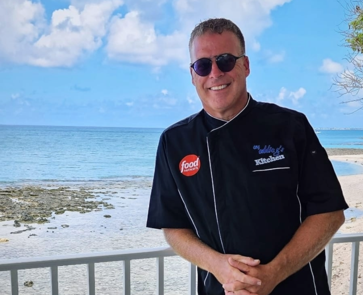 Chef Eddie G by the beach, smiling happily.
